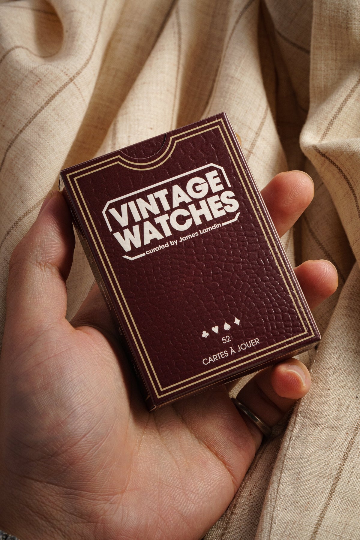 Vintage Watches playing cards held in the hand